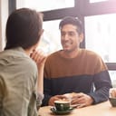 close-up of a couple enjoying a warm conversation over coffee on a date