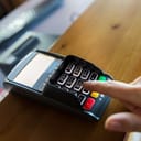 hand inputting a PIN code after card purchase