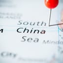 The South China Sea marked with a red pin on a map.