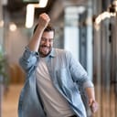 Man dancing in celebratory fashion with a smile on his face