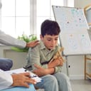 Sad child at session in psychologist's office. 