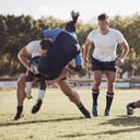 A football player tackling another team's player.
