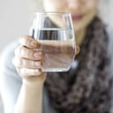 Woman holding up a glass of water