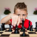 Close-up of boy playing chess