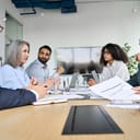 A group of people discussing business at table