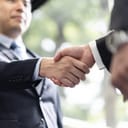 Japanese businessmen shaking hands for the first time in an office setting