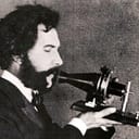 an actor portraying Alexander Graham Bell in a 1926 movie, holding Bell's original telephone transmitter