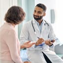 A male doctor talking to a female patient