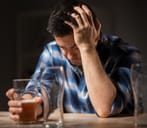 Sad man holding a glass of beer