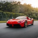 red ferrari 458 italia on road during daytime