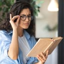 Woman suspiciously looking at a book she is holding