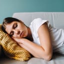Woman napping on sofa