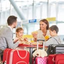 Family with children eating in restaurant before leaving the airport.