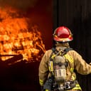 Firefighter looking at an object burning