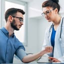 Man undergoing a medical check from a doctor
