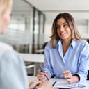 HR specialist interviewing a female recruit during a job interview in a modern office setting