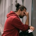 Disappointed man resting his head against his arm