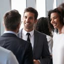People in business clothes talking with each other at a business party
