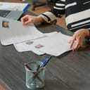 Woman looking at different job applications laid out on desk