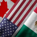 Close up of the flags of the North American Free Trade Agreement NAFTA members on textile texture. NAFTA is the world's largest trade bloc and member countries are Canada, United States and Mexico