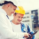 Two civil engineers looking at a tablet