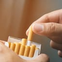 Person taking out a cigarette from a pack