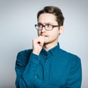 nervous man biting his nails isolated on a gray background