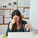 A tired teachers sitting in her office