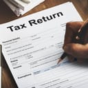 Person filling out a 'tax return' document