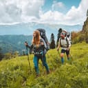 Family hiking in mountains travel adventure vacations group hikers couple with baby trekking outdoor healthy lifestyle eco tourism