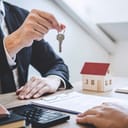 Real-estate agent giving a house key to a new owner