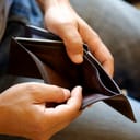 Person opening up an empty wallet