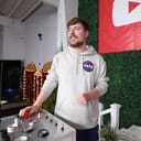 YouTuber MrBeast getting ready to press a red button on a large console