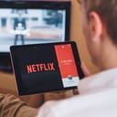 A man watching Netflix on his tablet
