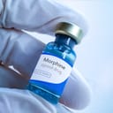 close-up of a person holding a little bottle of morphine, a pain medication from the opiate family
