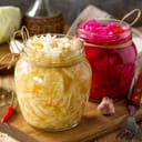 Homemade Sauerkraut with Carrot and Salad Cabbage with Beetroot on a wooden table
