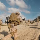 Soldiers in desert camouflage running in the field