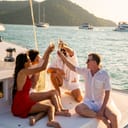 A group of friends savoring champagne on a luxury catamaran, enjoying a boat party during a sunset sail.
