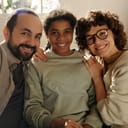 A joyful family with an adopted daughter taking a selfie portrait.
