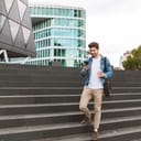 Man using his smartphone while walking in a city