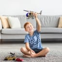 A young boy playing by himself with his toys