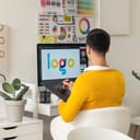 A designer creating a logo on their graphic tablet