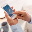 A senior woman checking a weather app on her phone