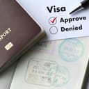 a top view of a visa and approved stamp on a passport
