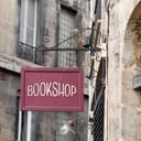 Vintage bookshop sign on a steel plate in an ancient European city street