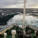 The bow of a ship splashed by a wave during a storm