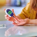 A person checking sugar levels in their blood