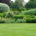 beautiful landscape of an English style garden with overflowing borders of flowers