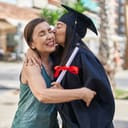 Mother hugging young graduate lady happy smiling