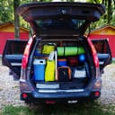 Travel car and camping luggage packed in the full car trunk. Outdoor wanderlust items. Outdoor, adventures and travel suv. Ready to go concept. Expedition, exploring swag and storage.